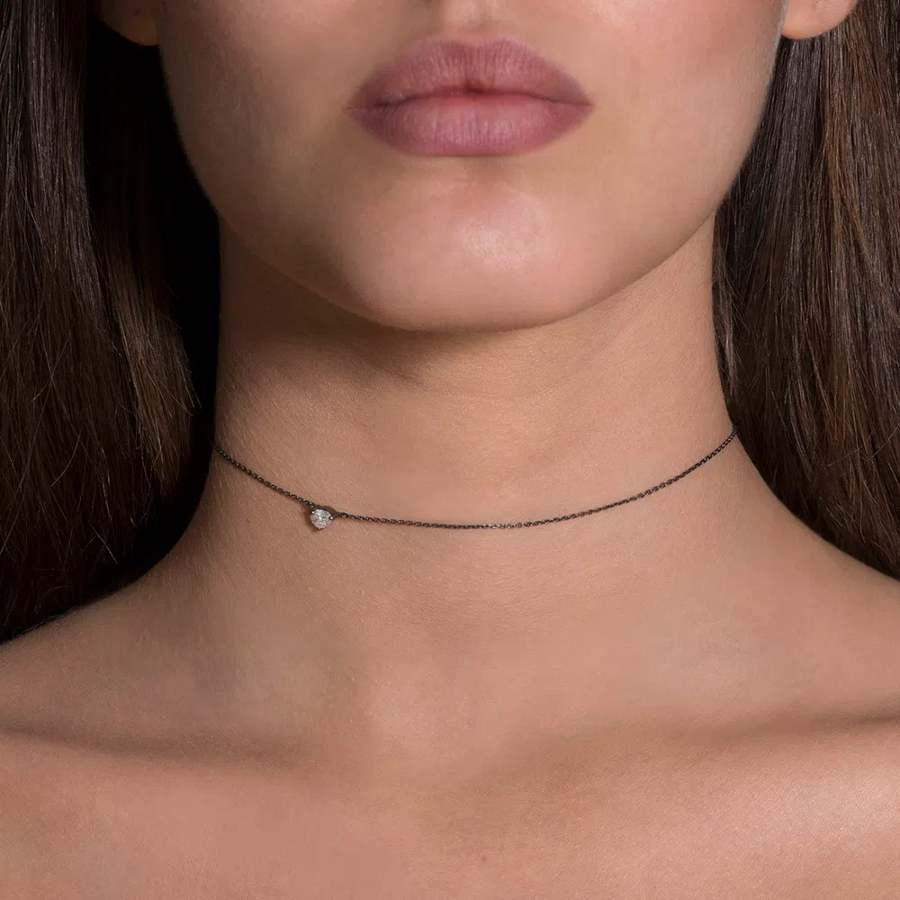 Front, zoomed view of a female model wearing the Choker Diamond Drop in her neck